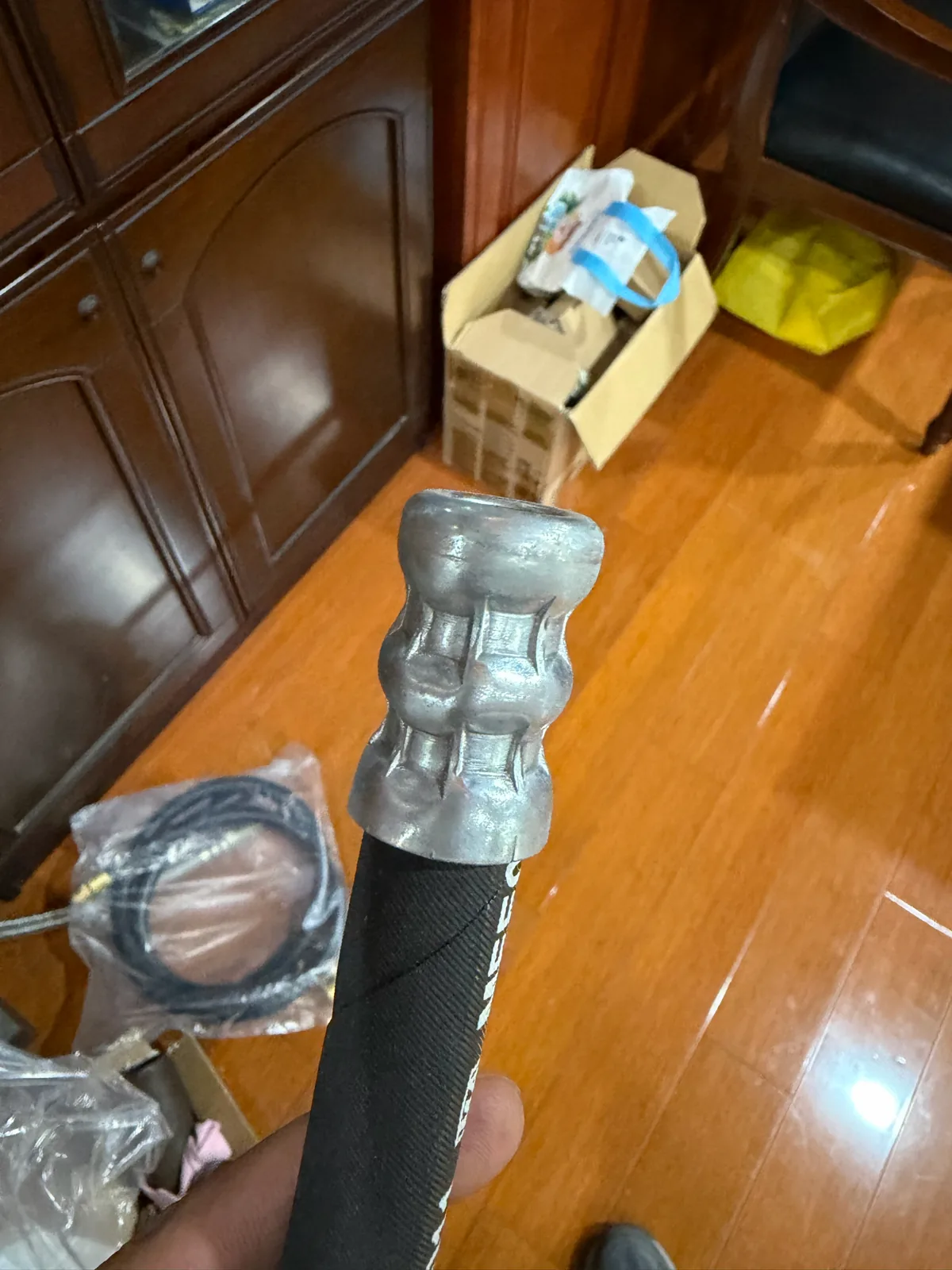 Crimped fitting shell on a hydraulic hose showing the even crimp pattern